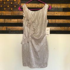 a dress hanging on a hanger in front of an american flag