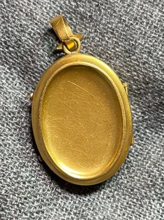 ". This beautiful oval locket has that gorgeous Victorian \"bloom\" to the gold that cannot be duplicated. It really can't be duplicated because the process has been illegal for almost 100 years now. The bale is an abstract fleur de lis shape. This locket is plated in 18k, thick enough to test 18k on the electronic tester! This locket does not have removable photo rings, but a printed picture could be carefully pressed in so it sits under the edge. I just print from my home printer on photo pape Classic Oval Locket Necklace Stamped 14k, Oval Cameo Keepsake Jewelry, Luxury Oval Locket Necklace As Gift, Elegant Antique Gold Oval Locket Necklace, Luxury Yellow Gold Oval Locket Necklace, Gold Oval Locket Necklace For Anniversary, Formal Gold Oval Locket Necklace, Gold Oval Pendant Locket Necklace, Oval Cameo Jewelry For Memorial