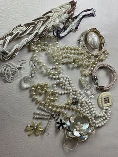 This is a 1/2 pound lot of broken and not, vintage and newer craft jewelry. The majority of these are wearable or for craft White tones There are necklaces, earrings, bracelets, key rings, broken pieces etc etc. Both vintage and modern. Perfect for your slow stitches or scrapbooking projects. Or other works of art This is NOT a mystery bag or box, so there will be no surprises You get everything in the picture. So study the pictures carefully !! Various materials such as plastic, metal, beads, e Costume Jewelry For Accessorizing, Assorted Vintage Necklaces For Gifts, Adjustable Assorted Jewelry, Vintage Adjustable Jewelry For Accessorizing, Adjustable Vintage Jewelry For Accessorizing, Elegant Assorted Jewelry For Gift, Vintage Handmade Assorted Jewelry, Handmade Vintage Jewelry In Assorted Colors, Assorted Vintage Handmade Jewelry