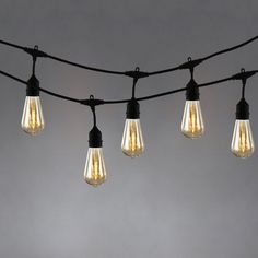 several light bulbs are hanging from a wire