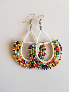 This listing is for ALL 9 pairs. The earrings are 100% handmade using original fine beads. Colorful and bright colors. ^^These earrings ships through dhl express. Buy multiple items and pay shipping for ONE item ONLY. Traditional Multicolor Round Hoop Earrings, Traditional Multicolor Hoop Earrings, Festival Colorful Beaded White Hoop Earrings, Festival White Hoop Earrings With Colorful Beads, Handmade Multicolor Round Beads Earrings, Multicolor Handmade Beaded Earrings, Traditional Multicolor Earrings With Large Beads, Traditional Beaded Dangle Hoop Earrings, Traditional Multicolor Beaded Hoop Earrings