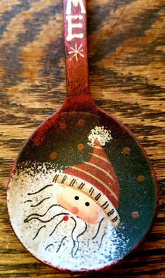 a spoon with a painted santa clause on it