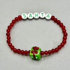 Gemstone Santa beaded stretch bracelet Genuine Jade approximately 7 inches Present is glass strung on professional latex free elastic. We do our best to choose each stone carefully and purposeful for every piece.. However there might be slight differences in color size shape and clarity which makes each item unique and one of a kind.Each piece of jewelry will come in a colored satin drawstring bag for it’s protection and storage or to be ready to give as a gift.Our gemstone jewelry are all origi Beaded Inelastic Bracelet As Gift, Inelastic Beaded Bracelets As Gifts, Inelastic Beaded Bracelet As A Gift, Flexible Beaded Stretch Bracelet Gift, Flexible Jewelry With Colorful Beads For Gifts, Flexible Bracelets With 8mm Beads For Gift, Flexible Colorful Beaded Jewelry For Gifts, Flexible Stretch Bracelet With Spacer Beads As Gift, Flexible Stretch Bracelet With Colorful Round Beads