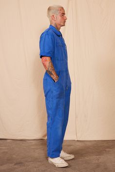 The jumpsuit you have been dreaming about. Our 80's Reworked Vintage Coverall Jumpsuit features an elastic waistband, with cool pocket and patchwork detailing. Featuring the iconic French working blue color, this is a must for any vintage enthusiast. This jumpsuit shows signs of wear, with some staining. Please see photos for details. Vintage often differs from today's modern sizing. Reference dimensions for fit. This product is not eligible for a return or refund as it falls under the "Vintage Item Sales Policy." Details: Brand: Moran's 100% Cotton Reworked 6 Pockets Zipper Front Dimensions: 22.5" Bust 32" Waist 44" Hip 28" Inseam 38" Outseam Measurements taken flat Care: Machine wash cold Tumble dry on low Care Instructions To maintain the quality of this uniquely dyed item, please wash Blue Denim Overall Jumpsuit With Pockets, Blue Shortalls With Pockets, Blue Fitted Utility Jumpsuit, Blue Fitted Utility Jumpsuits And Rompers, Retro Cotton Overalls With Relaxed Fit, Blue Relaxed Fit Denim Jumpsuit In Utility Style, Blue Denim Jumpsuit With Side Pockets, Retro Cotton Short Sleeve Jumpsuit, Blue Short Sleeve Jumpsuits And Rompers With Pockets