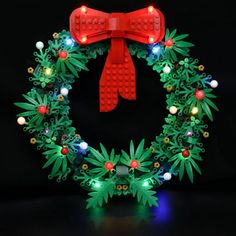 a christmas wreath made out of legos with lights and decorations on it's sides