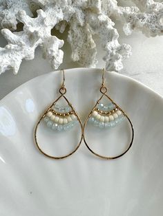 Welcome to SeashellandStoneco These elegant beach-style earrings feature beautiful aquamarine beads. Perfect for adding a touch of seaside charm to your look. MATERIAL 14K Gold-Filled Jewelry Ball End Ear Wire   Size : 11.5 × 20mm Aquamarine Rondelle  Size : 3mm Teardrop Charm Size : 35 × 25mm AROUT 14K GOLD-FILLED JEWELRY 14K gold-filled jewelry contains 5% solid gold. The gold layer is permanently bonded to the base metal through heat and pressure. With reasonable care, 14K gold-filled jewelry Handmade Teardrop Chandelier Earrings In 14k Gold Filled, Handmade Teardrop 14k Gold Filled Chandelier Earrings, Beach Teardrop Wire Wrapped Earrings, Nickel-free Gold Teardrop Beaded Earrings, Handmade 14k Gold-filled Teardrop Chandelier Earrings, Aquamarine Beads, Gold Filled Earrings, Earrings Inspiration, Beaded Hoops