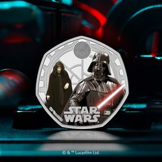 a star wars coin with darth vader and chew - oo character on it