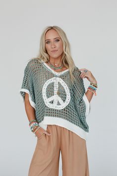 Cozy, cute, and embodying the perfect boho feel, the Peace Oasis Top brings all the peaceful vibes when you wear it! Comfy and cozy open knit fabric throughout Loose and slouchy silhouette for a relaxed fit Classic v-neckline and loose short sleeves for a comfortable, effortless look Contrast knit peace sign patchwork center design Slight high low bottom edge with ribbed knit trim along the bottom hem, sleeves, and neckline Pair with: Eye Of The Sun Padded Bralette, Frenchie Raw Edge Shorts and Boho Essentials, Bralette Outfit, Padded Bralette, Loose Shorts, Fall Collections, New Tops, Trending Accessories, Sweater Jacket, Outfit Sets