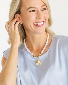 Our Marbella Pearl Necklace is the epitome of classy and timeless style. Connected to the pendant by our signature Bentley Beads, freshwater pearls give this piece an heirloom feel. Wear it as an accessory to your beachside ensemble with our Marbella Studs or as the perfect piece to complement your happy hour mini dress. White Shell-shaped Jewelry With Pearl Pendant, Ocean-inspired Mother Of Pearl Jewelry With Pearl Charm, Elegant Pearl White Jewelry For Beach, White Pearl Necklace With Ocean-inspired Style, Pearl White Shell-shaped Pearl Chain Jewelry, Elegant Shell-shaped Pearl Drop Necklace, Elegant Pendant Shell Necklace, White Ocean-inspired Jewelry With Round Beads, Ocean-inspired White Round Bead Jewelry