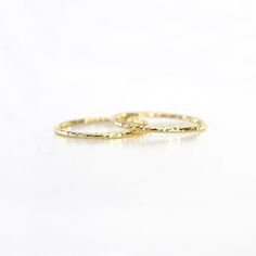 Prasanna Ring Delicate 14k Gold Band, Dainty Hammered Yellow Gold Rings, Elegant Hammered Stackable Rings, Delicate Hammered Yellow Gold Ring, Yellow Gold Hammered Stackable Rings, Gold Hammered Stackable Rings, Gold Hammered Stackable Round Band Rings, Elegant Hammered Stackable Rings In Recycled Gold, Elegant Gold Stackable Wedding Rings