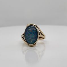 A very fine vintage gold and opal signet style ring.  With oval opal doublet cabochon bezel set in 9ct gold.   Simply a great ring!  Date: 20th Century  Overall Condition: It is in overall good, as-pictured, used estate condition with some very fine & light surface scratches and other signs of expected light wear consistent with age.  Fineness: Marked 9ct for gold fineness.    Marks: 9ct  Measurements: Height: ca. 23 mm Length: ca. 17 mm Width: ca. 19 mm  Weight: ca. 3.5 grams  Ring Size: 6.75 Classic Cabochon Opal Ring, Formal Opal Ring With Polished Finish, Classic Cabochon Opal Ring For Formal Occasions, Classic Oval Opal Ring With Polished Finish, Heirloom Oval Opal Ring For Formal Occasions, Oval Cabochon Opal Ring With Polished Finish, Formal Hallmarked Oval Cabochon Opal Ring, Formal Oval Cabochon Opal Ring, Classic Opal Ring With Polished Oval Cabochon