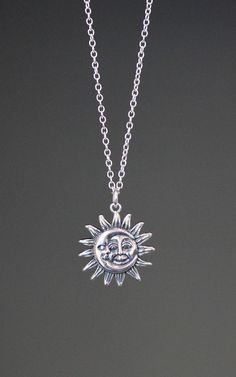 "This beautifully detailed Bali Silver Sun and Moon charm dangles from a silver chain. The chain is adjustable and can be worn close to the neck at 16\" or a little longer at 18\". It is finished with a silver lobster clasp. Please send a message if a longer chain is desired. Wear this necklace by itself or as a layering piece. Coordinating earrings are available... www.etsy.com/listing/1175529018/silver-sun-earrings Silver Sun and Moon pendant: 19mm Total length of charm: 1\" Silver chain: 1.5m Sun And Moon Jewelry Silver, Silver Necklace Moon, Celestial Sun And Moon Sterling Silver Necklace, Sun Necklace Silver, Silver Moon Charm Necklace With Adjustable Chain, Sterling Silver Sun And Moon Pendant Charm Necklace, Silver Celestial Charm Necklace For Everyday, Silver Celestial Charm Necklaces For Everyday, Sterling Silver Pendant Necklace With Sun And Moon Design