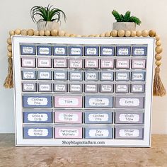 a wooden table topped with lots of drawers filled with boxes and planters on top of it