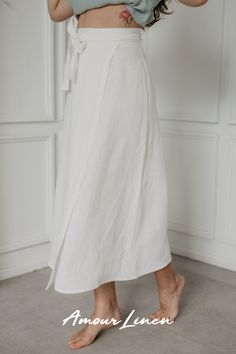 The beautiful midi-length wrap skirt "Iris" by AmourLinen is a versatile addition to any wardrobe. Its wrap style allows for simple outfits with sneakers and a top or a stylish beachy look with a swimsuit. Wear it to work, a picnic, or even a bigger occasion, such as a wedding! Choose from 13 colors and 2 sizes. Elegant Relaxed Wrap Skirt, White Wrap Skirt Outfit, Elegant Wrap Skirt With Relaxed Fit, Elegant Wrap Flowy Skirt, Elegant Wrap Skirt With Lining, Spring Tie Waist Midi Wrap Skirt, Elegant Summer Wrap Skirt With Lining, Spring Wrap Skirt With Tie Waist, Spring Midi Wrap Skirt With Tie Waist