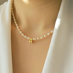 Drape yourself in elegance with our Personalized Letter Necklace adorned with natural pearls and 14/20 gold-filled beads, a graceful tribute to refined simplicity. Ideal for everyday wear, this necklace adds a touch of sophistication to your look. Whether for yourself or a loved one, it makes for a thoughtful and personalized gift, capturing the essence of timeless beauty in every letter and pearl. *Personalized pieces take between 2-4 business days to ship* Handcrafted in USA DETAILS: Material: Elegant Pearl Jewelry With Letter Beads, Elegant Gold Letter Bead Necklaces, Gold Elegant Necklaces With Letter Beads, Elegant Gold Necklaces With Letter Beads, Elegant Gold Pearl Necklace With Letter Beads, Gold Beaded Necklace With Pearl Drop As Gift, Pearl Necklace With Gold Beads For Gift, Gold Beaded Necklace With Pearl Drop For Gift, Personalized Gold Pearl Necklace For Mother's Day