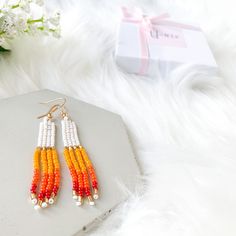 Beautiful White & multicolor hand-beaded earrings. These pairs of rainbow tassel earrings are the perfect earrings for you or for that special gift that you are looking for. They are made with high-quality seed beads and gold-plated ear wires, so if you like them, choose your variation and add click Add to cart and we will prepare them for you. You will receive one pair of earrings available in 2 options: sunset and purple sunset.  Item description:   Materials: -Seed beads in size 11/0 -Gold pl Summer Tassel Earrings Gift, Trendy White Tassel Earrings For Summer, Trendy White Tassel Drop Earrings, Bohemian Rainbow Jewelry For Summer, Colorful Beaded Adjustable Earrings As Gift, Bohemian Rainbow Summer Jewelry, Adjustable Colorful Beaded Earrings As Gift, Adjustable Colorful Beaded Earrings For Gifts, Bohemian Orange Jewelry For Summer