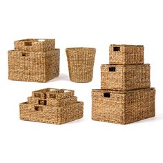 four wicker baskets with lids and handles on each side, all in different sizes