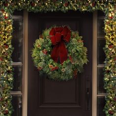 a christmas wreath is hanging on the front door