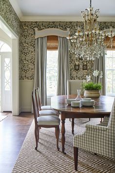 a dining room table with chairs and a chandelier