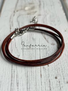 "Introducing the 'Rustic Wrap' Multistrand Leather Bracelet - a true embodiment of classic craftsmanship and natural style. This bracelet features multiple strands of supple brown leather, carefully designed to wrap comfortably around your wrist, creating a layered look that's both stylish and substantial. Secured with a sturdy clasp, it's adjustable to ensure the perfect fit for any wrist size. Whether it's a casual day out or an evening event, this wrap bracelet is the ideal accessory to bring Brown Leather Strap Bracelet, Adjustable Double Band Brown Wrap Bracelet, Brown Double Band Bracelet With Leather Strap, Brown Double Band Leather Strap Bracelets, Brown Leather Strap Double Band Bracelets, Brown Double Band Leather Bracelets, Brown Leather Wrap Bracelet As Gift, Brown Leather Wrap Bracelet Gift, Brown Leather Wrap Bracelet For Gift