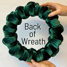 two hands holding up a green wreath with the words back of wreath written in it