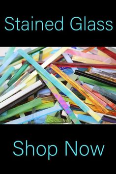 a pile of colored glass sticks sitting on top of a black background with the words stained glass shop now