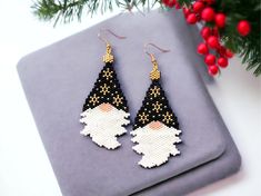 a pair of black and white beaded gnome earrings