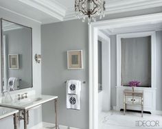 a bathroom with a chandelier and two sinks