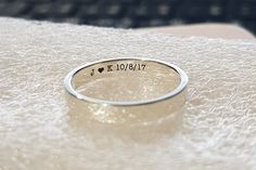 a silver ring that says i love you on it sitting on top of a white towel