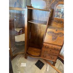 an old dresser and mirror are on display in a room with other antique furniture items