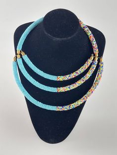 African beaded necklace - sky blue and multicolor African jewelry  - Maasai beadwork - ethnic necklace for women African beaded necklace made with maasai color beads. Its a perfect accessory that will match most of your outfits. Suitable for any season. Handmade Light Blue Multi-strand Jewelry, Handmade Blue Multi-strand Necklace, Handmade Light Blue Necklaces, Handmade Adjustable Light Blue Necklace, Adjustable Handmade Light Blue Necklace, Turquoise Beaded Bib Necklaces, Unique Multicolor Beaded Turquoise Necklace, Blue Beaded Chain Bib Necklaces, Unique Multicolor Turquoise Necklace With Colorful Beads