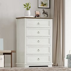 a white chest of drawers in a living room