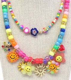 Rainbow beads,  smiley face charms, flowers, sunshine.  and hearts theme multi charm multi layer necklace and gold ball stud earrings set is fun,  happy, and fabulous!!  Size: Length 16 inches on shortest layer the gold tone paper clip chain the necklace has 3 inch extender chain Cheap Multicolor Beaded Charm Necklace, Playful Handmade Adjustable Charm Necklaces, Cute Multicolor Jewelry With Heart Beads, Cute Multicolor Heart Beads Jewelry, Rainbow Bohemian Jewelry For Spring, Whimsical Multicolor Jewelry With Charms, Whimsical Multicolor Charms Jewelry, Playful Summer Dangle Jewelry, Bohemian Rainbow Jewelry For Spring