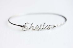 Vintage Name Bracelet - Sheila Silver Metal Name Bracelets, Silver Metal Bracelets With Name Detail, Silver Custom Name Bangle Bracelet, Custom Name Silver Bangle Bracelet, Nickel-free Vintage Bangle As A Gift, Silver Name Bracelet In Metal, Adjustable Silver Bangle With Custom Name, Vintage Adjustable Charm Bracelet With Engraving, Silver Metal Name Bracelet