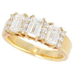 A Three Stone Emerald-Cut Diamond Band with Round Diamonds in 18 Karat Yellow Gold. The Diamonds weigh 1.22 carats, Total Weight: 5.42 grams. Ring Size US 5.75. Wedding Ring Goals, Fancy Diamond Ring, Emerald Band, Emerald Cut Diamond Ring, Wedding Rings Round, Gold Ring Designs, Diamond Anniversary, Stone Gold, Emerald Cut Diamonds