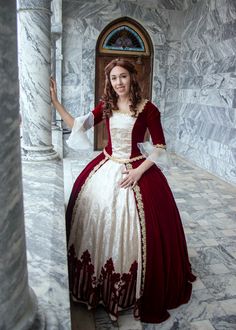 a woman in a red and white dress is posing for the camera