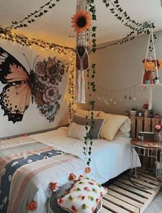 a room with a bed, table and hanging decorations