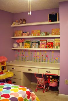 a child's bedroom with purple walls and white shelves