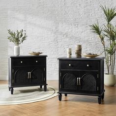 two black side tables sitting on top of a wooden floor