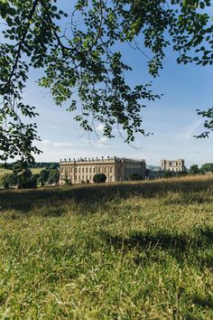 a large building sitting on top of a lush green field