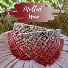 two crocheted bags sitting on top of a cushion with the words milled wine written above them