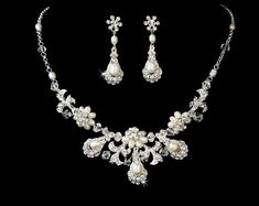 "Exquisite wedding necklace earring set with ivory freshwater pearls, dazzling clear rhinestones and fabulous clear Austrian crystal beads all set in stunning gold or silver plating in a vintage inspired floral design. This wedding jewelry set will make you feel absolutely beautiful and will look wonderful on any classic or vintage inspired bride with a white,ivory,champagne or blush wedding dress. READY TO SHIP in Silver, Gold sold out. DETAILS: - Necklace - Necklace: 15\" long with a 2\" adjus Silver Pearl Bridal Sets For Formal Occasions, Formal Silver Pearl Bridal Sets, White Rhinestone Bridal Necklace For Anniversary, Wedding Jewelry With Pearl And Diamond Accents, Pearl Bridal Earrings With Diamond Accents For Wedding, Bridal Pearl Earrings With Diamond Accents For Wedding, Elegant White Bridal Sets With Pearl Drop, White Dangle Jewelry Sets For Formal Occasions, Wedding Pearl Necklace With Diamond Accents