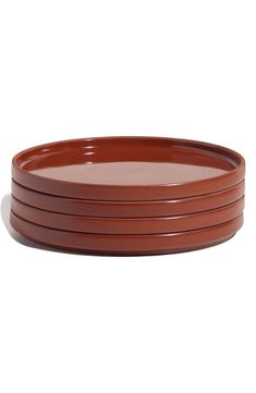 four brown plates stacked on top of each other