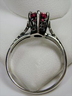 Simulated Red Ruby Ring Wedding #D22 This is a Victorian Era solitaire ring. This lovely sterling silver wedding solitaire has an approximately .5 carat simulated red ruby gemstone. This full cut flawless gemstone is 6mm (1/4") in diameter. The inside of the band is marked 925 for sterling silver. Notice the beautiful crown design of the silver filigree setting and the etched band. This is a lovely rendition of an Antique filigree ring. Classically fashioned, this ring is a vintage wedding style Antique Filigree, Victorian Wedding, Crown Design, Vintage Style Wedding, Ruby Gemstone, Filigree Ring, Engraved Items, Ruby Ring, Silver Filigree