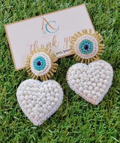 Handmade evil eye earrings, Venezuelan Design in Miami. Unique, not repeated. Super cute for your outfit, you can wear it day or night Size: 3 inches long Material: beads Our earrings are handmade, exclusive to our brand, each model is unique, they are not repeated. We work with excellent materials, natural stones, gold plated, soutache, tassels, crystals, stainless steel and many more of the best quality. Check all the models that we have available in our link www.etsy.com/shop/ACAccessoriesMiami Follow us on instagram @acaccessoriesmiami to find out about everything new we have every day, check all our products, share your photos with our products and be one of our beautiful published clients White Heart Beads Drop Earrings, White Drop Earrings With Heart Beads, White Heart Drop Earrings For Party, Trendy White Heart-shaped Earrings, Trendy White Heart Earrings For Gift, Trendy White Heart Earrings Gift, White Heart-shaped Beach Jewelry, White Heart Bead Dangle Earrings, White Heart Beads Dangle Earrings