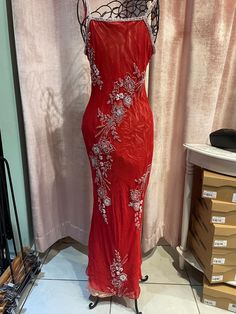 a red dress on display in front of a window