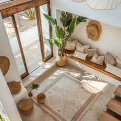 a living room filled with lots of furniture and plants