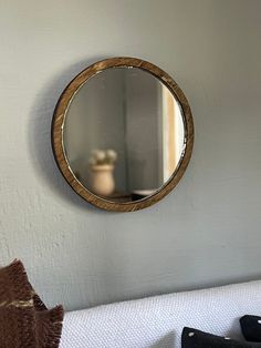 a mirror hanging on the wall above a bed