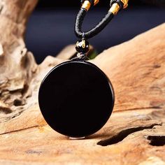 This stunning true black obsidian scrying mirror necklace helps you get in touch with your unconscious minds: the realm of the soul. A wonderful divination tool to get in touch with your core needs, dreams and goals. Black Obsidian Stone is a powerful cleanser of psychic smog created within your aura and is a strong psychic protection stone. This stone has powerful metaphysical properties that will help to shield you against negativity. The energy of these stones may stimulate the gift of prophe Black Obsidian Amulet Necklaces, Black Obsidian Amulet Necklace, Black Amulet Jewelry For Meditation, Black Obsidian Necklaces For Meditation, Black Obsidian Necklace With 108 Beads, Black Obsidian Necklace For Healing, Black Obsidian Necklace For Meditation, Black Spiritual Medallion Jewelry, Black Pendant Crystal Necklaces For Meditation