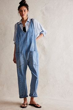 One-and-done and so simple, this denim jumpsuit from our We The Free Collection is featured in a relaxed fit and cropped ankle-length style with harem legs and a low scoop neckline. **Fit:** Slouchy, relaxed fit; ankle-length, pull-on style **Features:** Denim fabrication, rigid feel, low scoop neckline, seam detail throughout, oversized patch pockets, drop-crotch harem-style legs, low back with adjustable shoulder straps **Why We | We The Free High Roller Jumpsuit at Free People in Light Wash, Cheap Relaxed Fit Denim Jumpsuit, Denim Jumpsuits, High Roller, Tie Sleeve, Strapless Mini Dress, Denim Jumpsuit, Amelie, Low Back, Boho Outfits